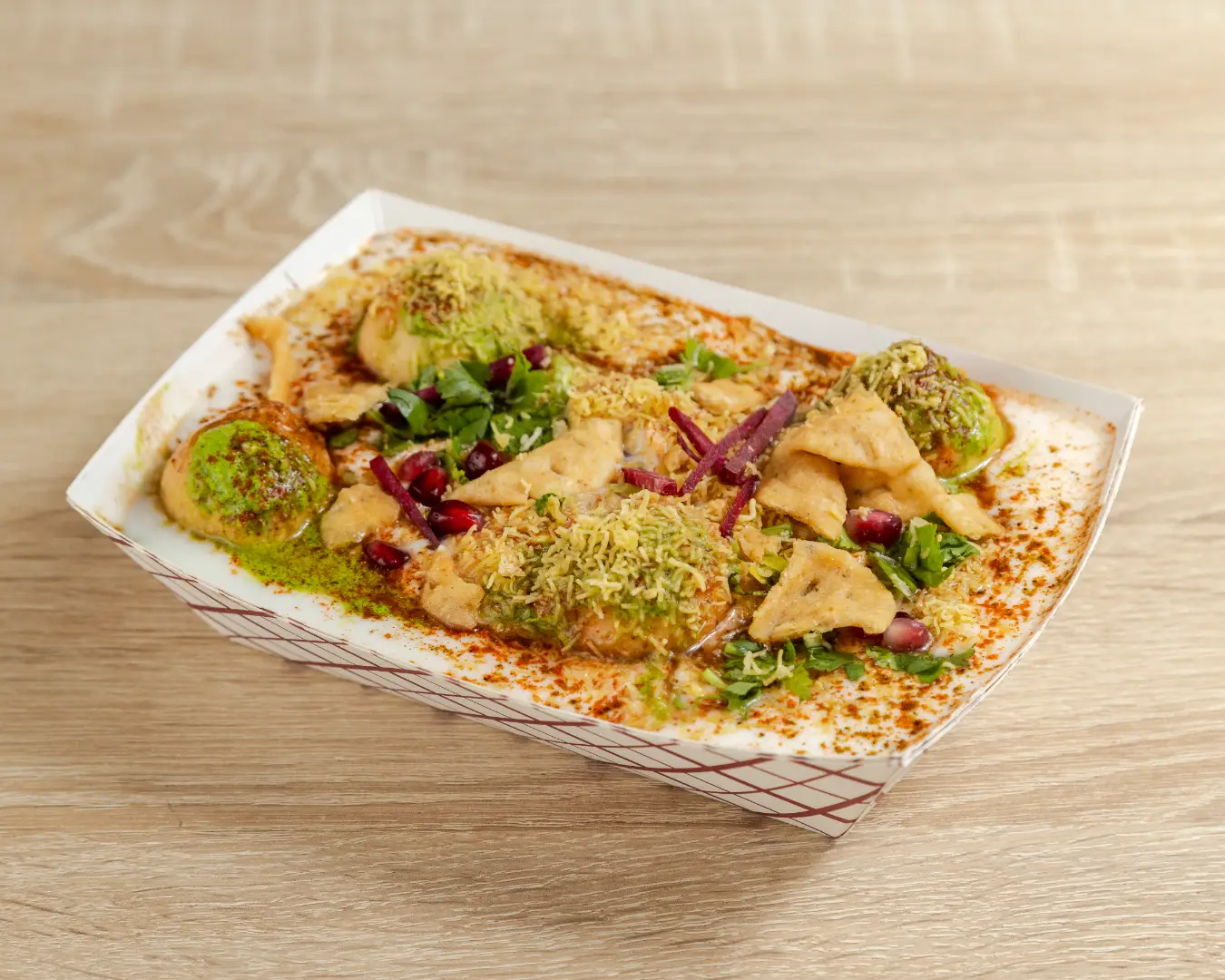 Bhalla Papdi Chaat topped with yogurt and dhaniya coriander on Indian street food chaat in Brampton